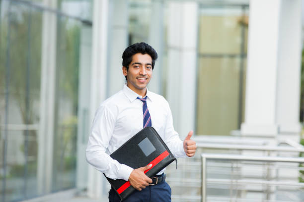 A professional from 3webindia.com giving a thumbs-up outside an office building